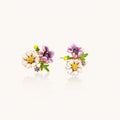 Cluster-style stud earrings with purple pansies, white daisies, yellow centers, and green leaves in glossy enamel finish