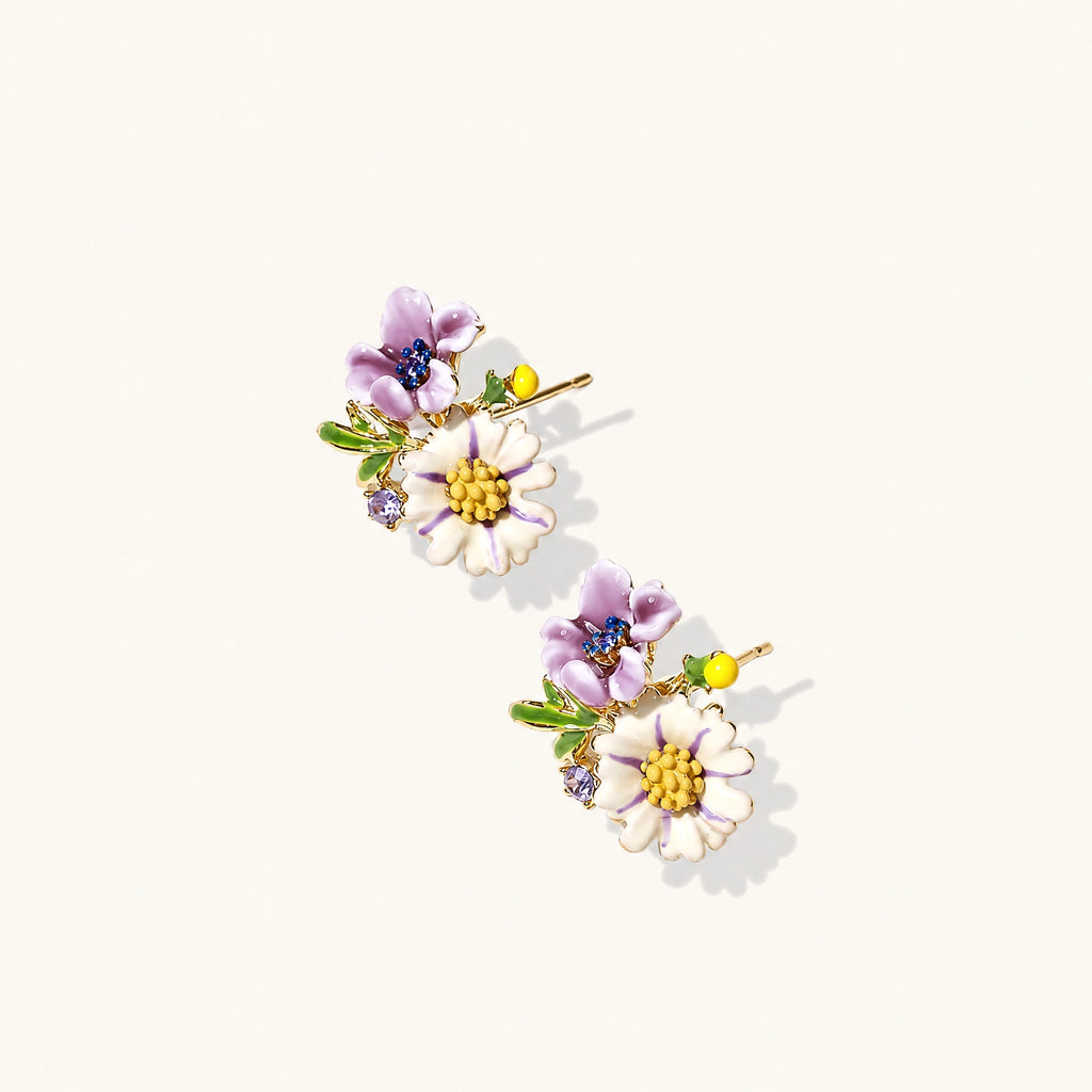 Cluster-style stud earrings with purple pansies, white daisies, yellow centers, and green leaves in glossy enamel finish