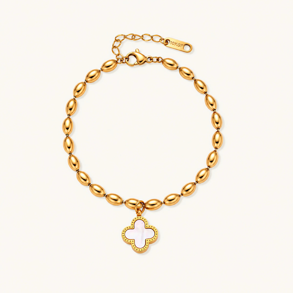 18K gold-plated oval bead bracelet with a four-leaf clover charm in mother-of-pearl or black enamel, adjustable lobster clasp, on white background.