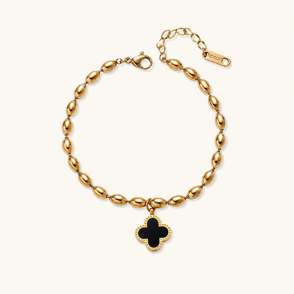 18K gold-plated oval bead bracelet with a four-leaf clover charm in mother-of-pearl or black enamel, adjustable lobster clasp, on white background.