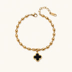 18K gold-plated oval bead bracelet with a four-leaf clover charm in mother-of-pearl or black enamel, adjustable lobster clasp, on white background.