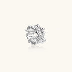 Wide band ring with sculptural wave ripples in polished white gold plated eco-brass on cream background