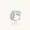 Wide band ring with sculptural wave ripples in polished white gold plated eco-brass on cream background