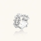 Wide band ring with sculptural wave ripples in polished white gold plated eco-brass on cream background