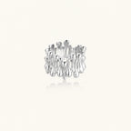 Wide band ring with sculptural wave ripples in polished white gold plated eco-brass on cream background
