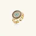 Gold chain ring with Greek key border and turquoise evil eye center on white background
