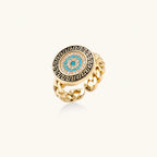 Gold chain ring with Greek key border and turquoise evil eye center on white background