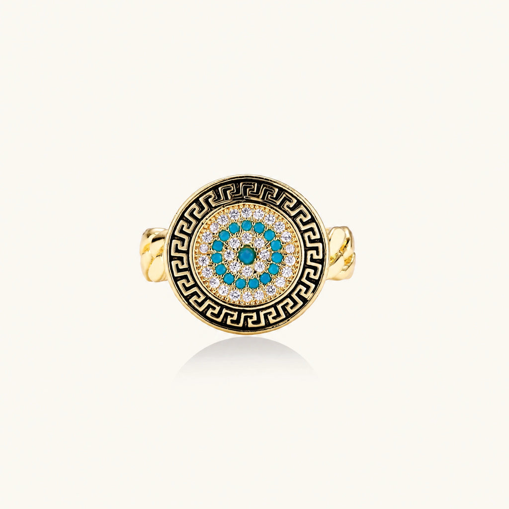 Gold chain ring with Greek key border and turquoise evil eye center on white background