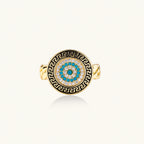 Gold chain ring with Greek key border and turquoise evil eye center on white background