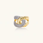 Chunky gold-plated chain-link ring with curved segments and sparkling zirconia crystals on neutral background