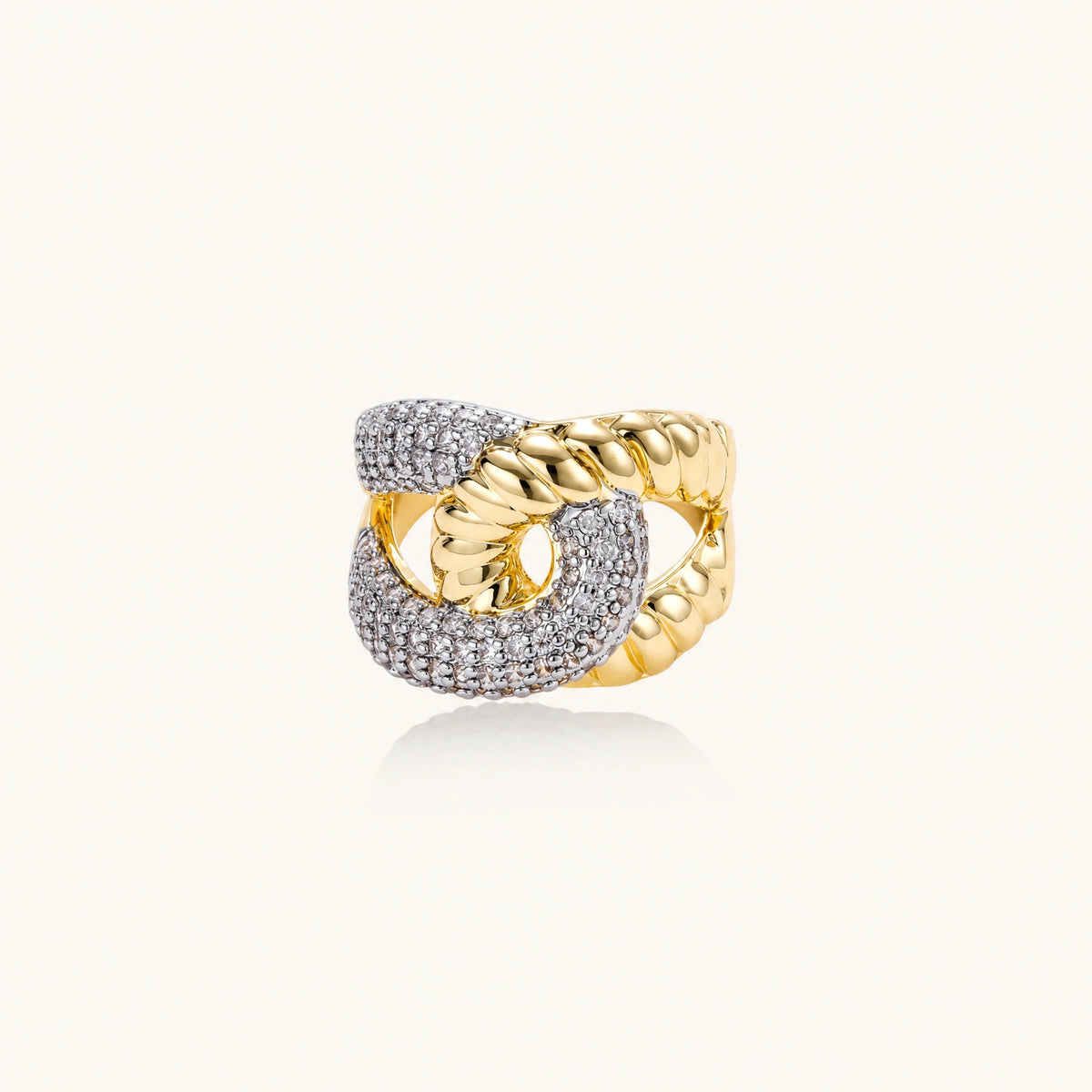 Chunky gold-plated chain-link ring with curved segments and sparkling zirconia crystals on neutral background